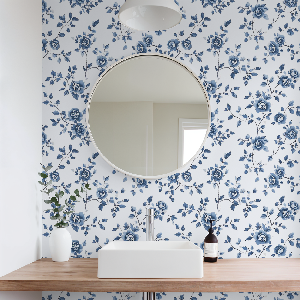 Bathroom with floral wallpaper, round mirror, and sink.