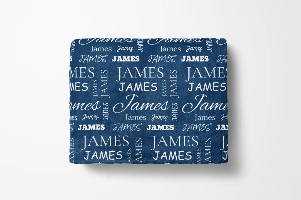 Folded blue blanket with 'JAMES' text pattern on a white background