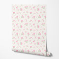 Roll of floral wallpaper with pink flowers on a white background